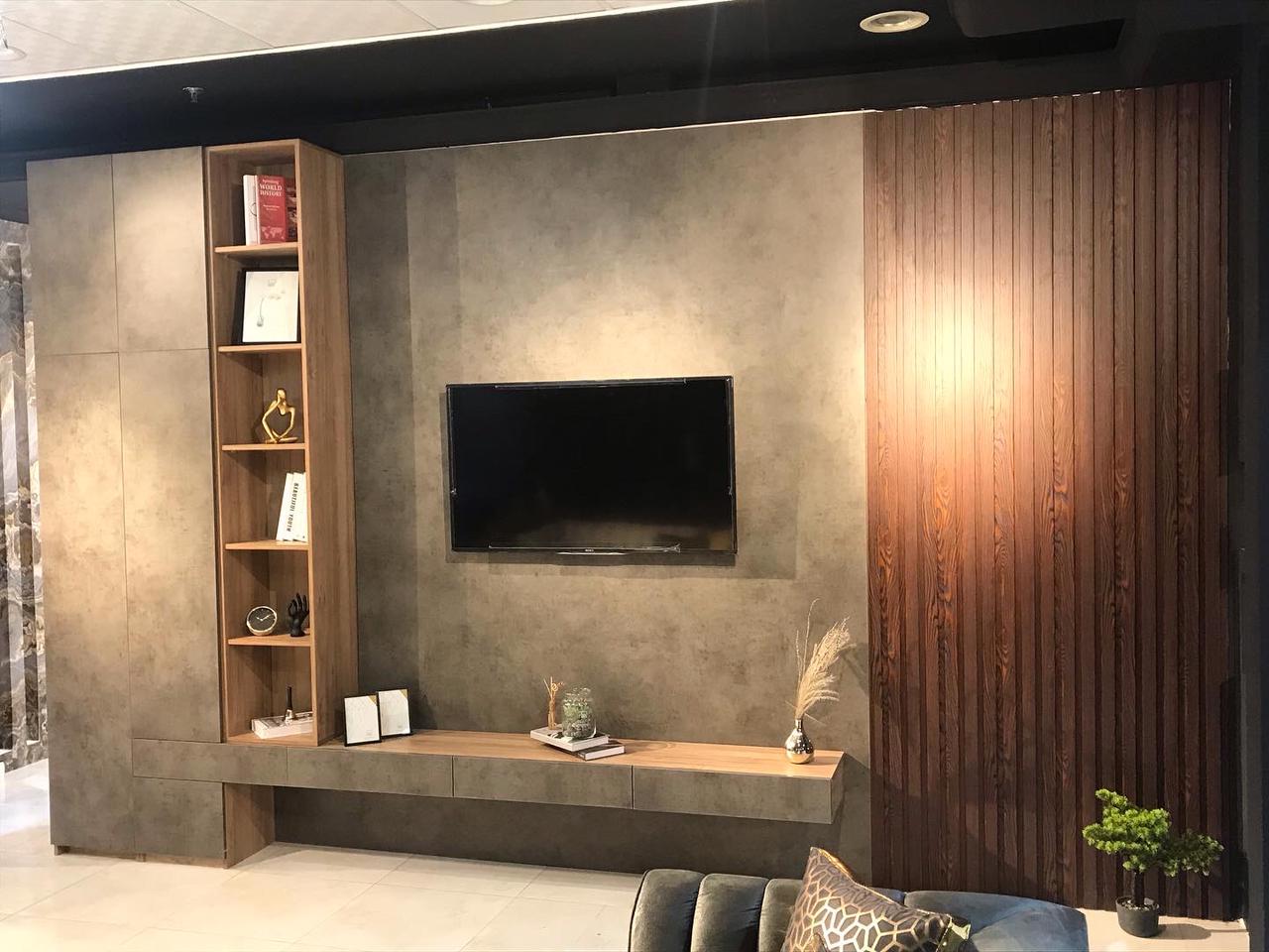Custom TV media unit with stone, walnut paneling and slim shelving